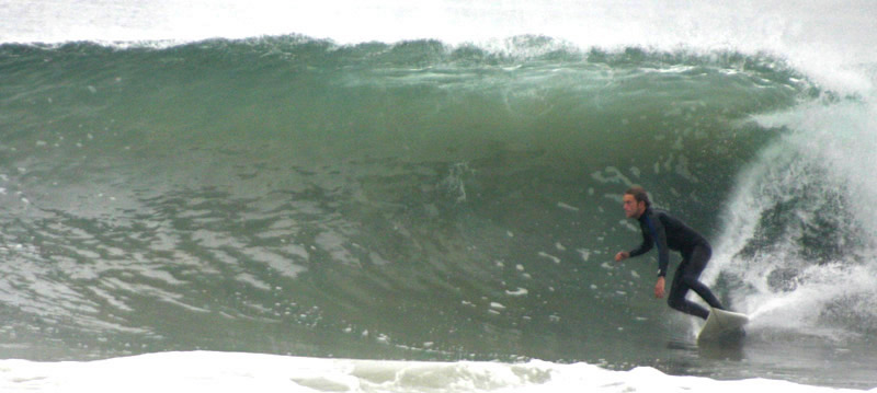 Surfer making a bottom turn at Sands Beach