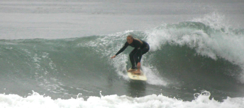 Woman surfing at Sands Beach