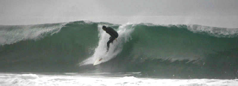 Surfer falling from a wave at Sands Beach